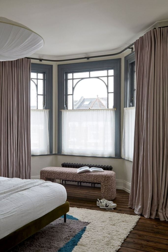 Cafe curtains will add privacy, block the view and let the daylight in. 

(via interiordesigners).