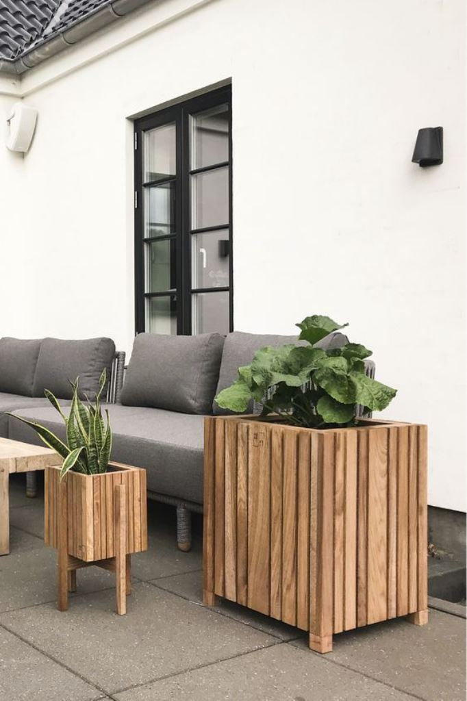 This duo of matching slat planters spruces up the space and makes it look more modern.