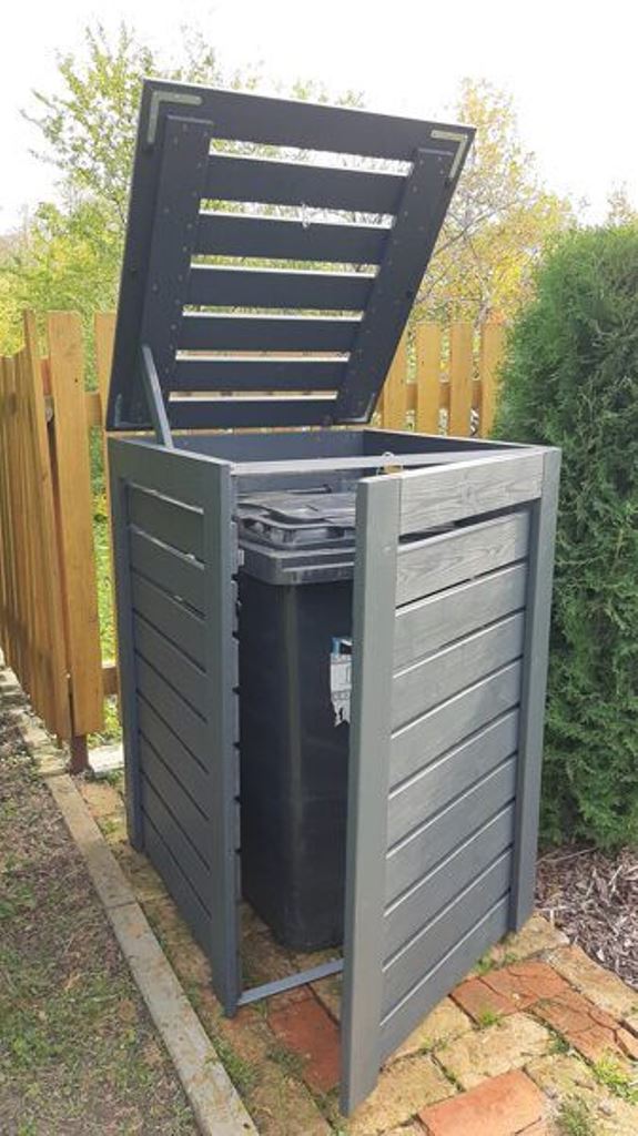 This small grey wooden box is a slatted one, with a lid and a door.