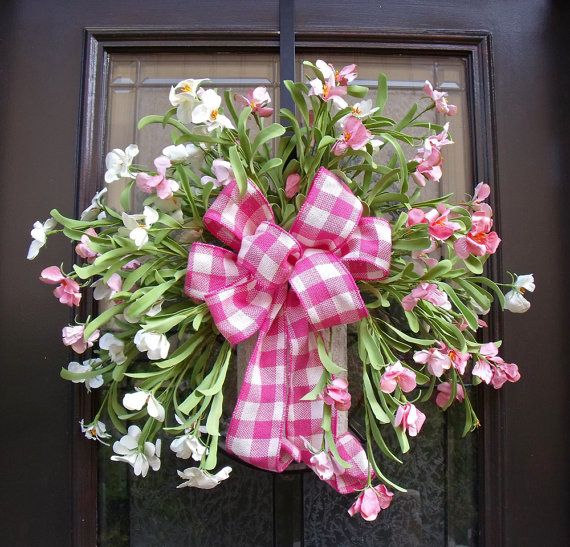 A fresh pink bloom wreath with a pink plaid bow is a bold summer-like decoraiton for your front door.