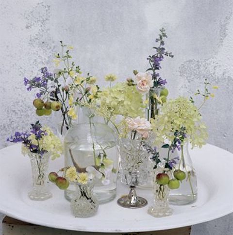 Vintage sheer glasses and vases with various wildflowers will give a slight summer feel to the space and can fit both a vintage and a boho space.