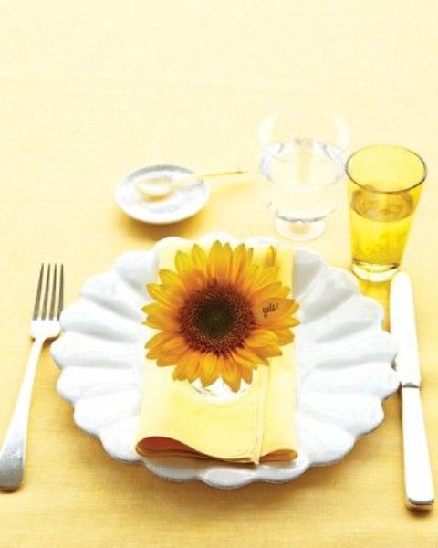 Accentuate each place setting with a single bold bloom to give it a bright and cool summery feel.