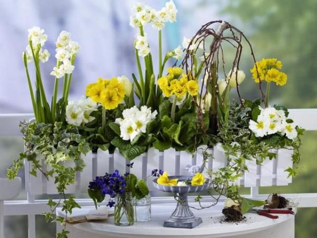 A white fence planter with neutral and yellow blooms will brign a bright summer touch to any of your spaces.