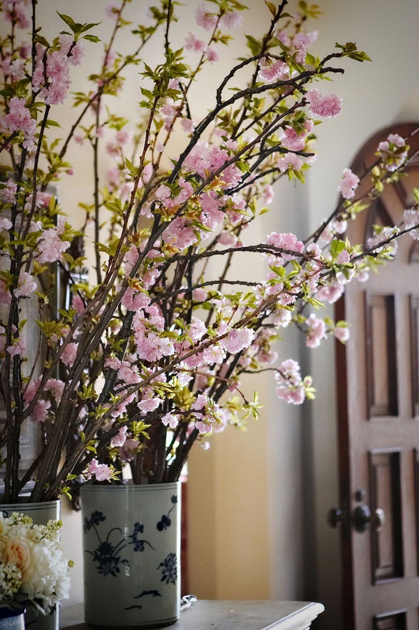 Vintage vases with blooming cherry branches are always a good idea for every space, both indoor and outdoor.