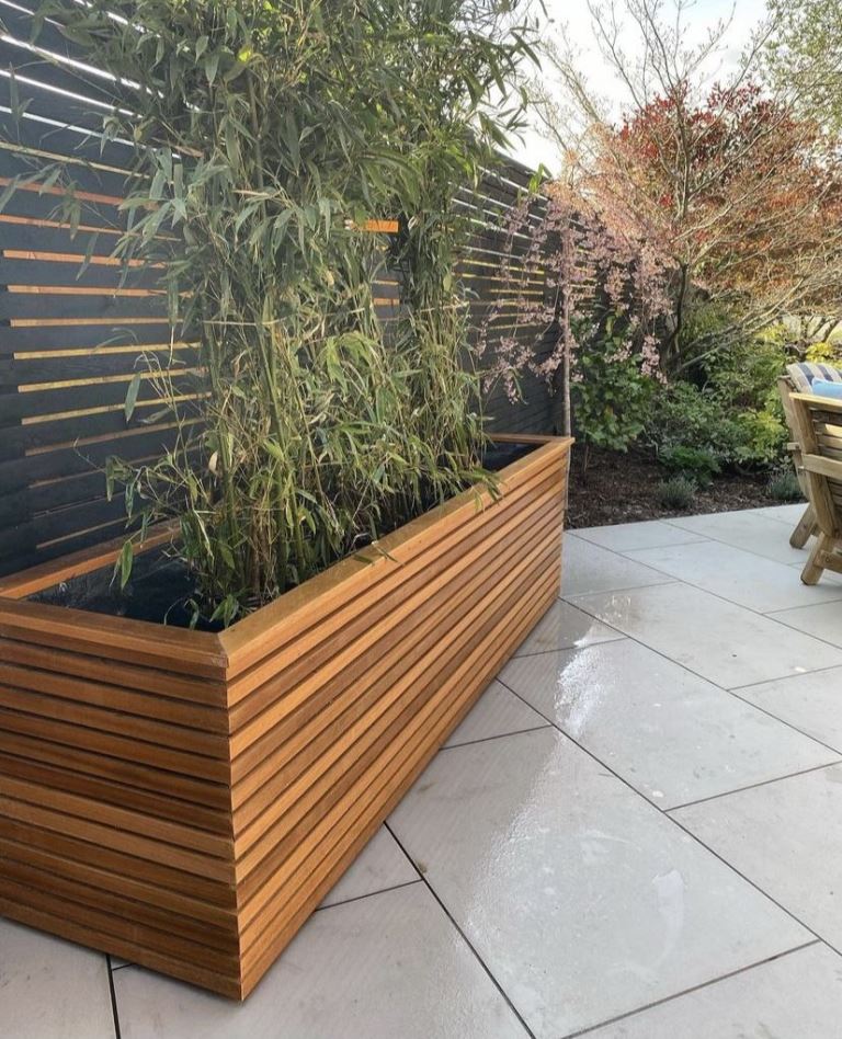This large long planter is a cool solution for a modern deck, and if you choose tall plants, it will be a cool space divider.