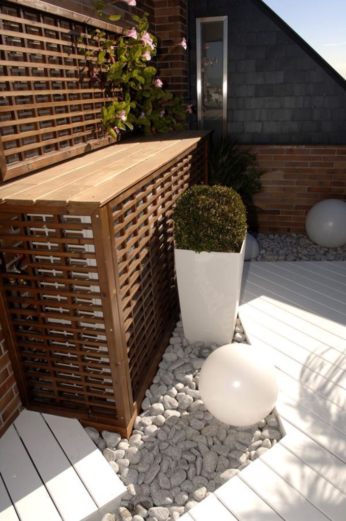 This tall outdoor console table doubles as an AC cover that perfectly matches the style of the space.