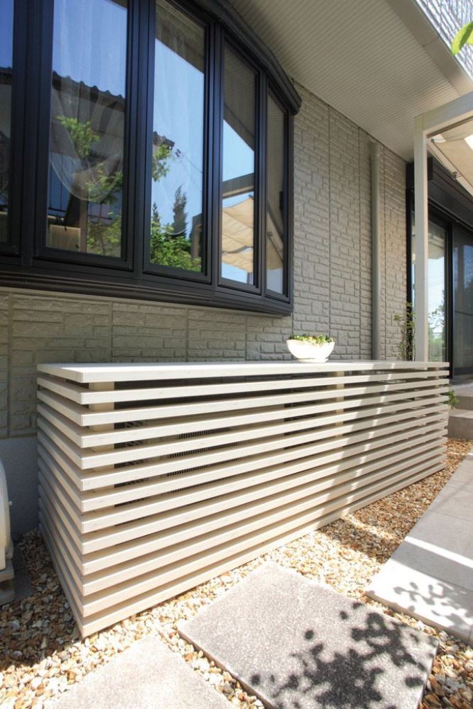 The duo of AC units is covered with a long slatted console that can be used as a plant stand.
