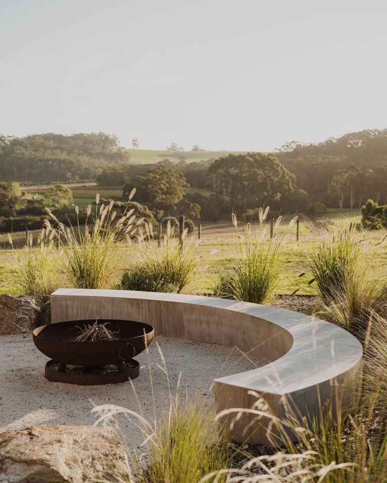 This terrace shows off a curved slab bench and a fire bowl plus grasses around, and this is a lovely modern landscape.


(via instagram).