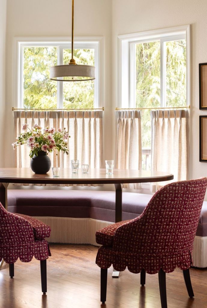 The windows are styled with pleated cafe curtains that block the view but not light and keep privacy.