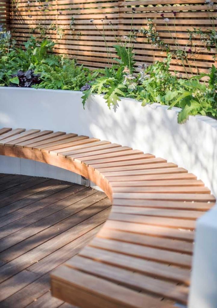 The contemporary patio features a raised garden bed and a floating bench attached to it. 

(via eyre-design).