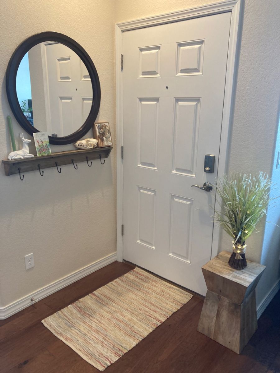 A mirror and a rack with hooks are placed behind the door, and as the entryway is small, this is a smart solution.