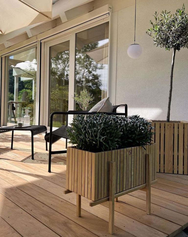 The raised slat planter like this one is a super stylish solution, and legs make it look out-of-the-box.