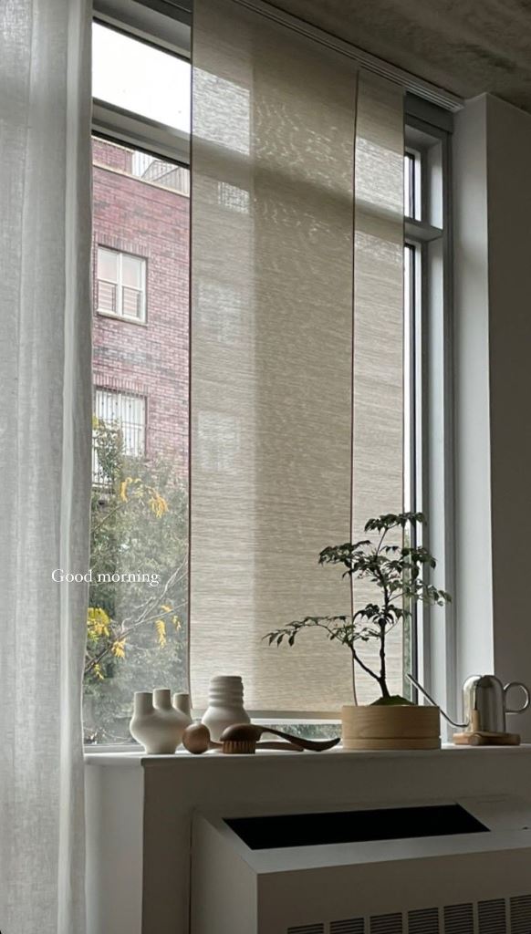The semi-sheer Roman shades delicately cover the window and can be moved whenever necessary.