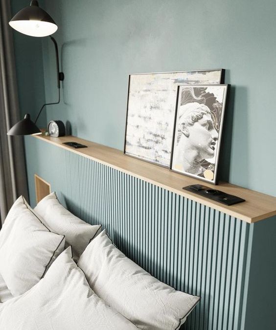 The beautiful aqua space is finished off with a matching ribbed storage headboard, with decor on top.