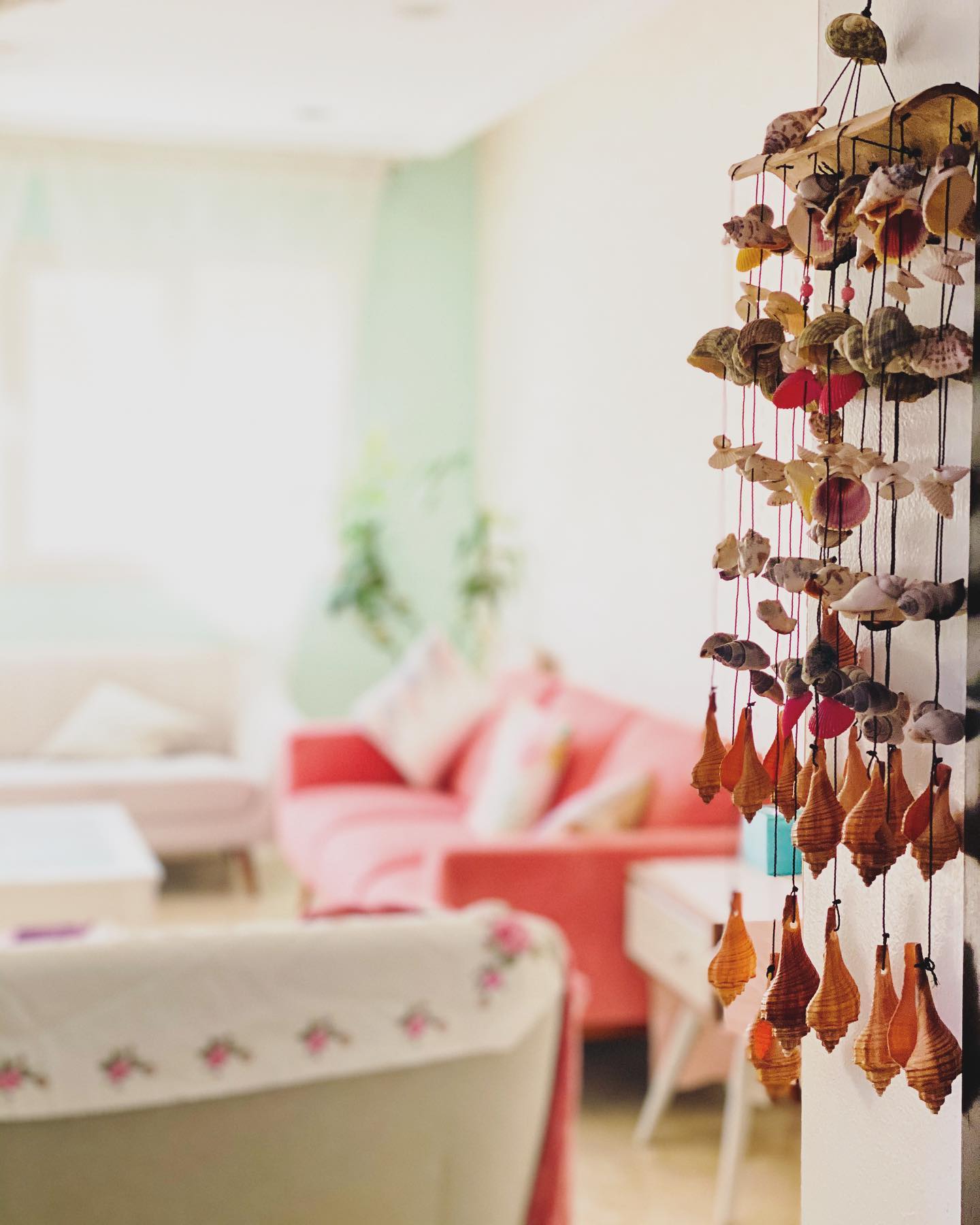 A charming mobile of various shells hanging by string in layers, creating a breezy, ocean-inspired accent that adds texture and movement to your space.

(@latifahshoots_).