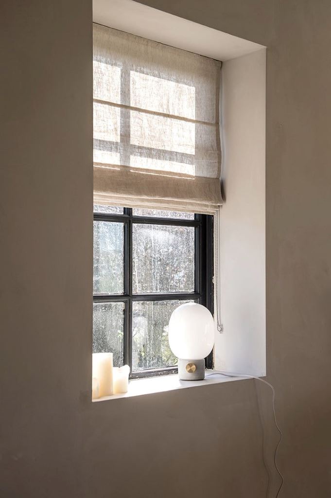 The small window is done with a semi-sheer textural shade that matches the color and texture of the walls.