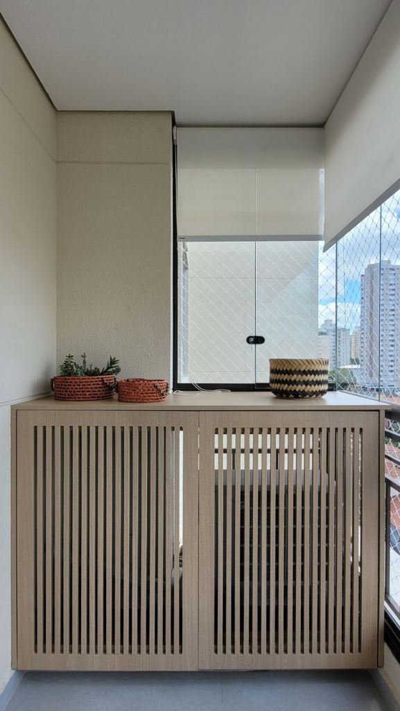 The large stylish cabinet with slatted doors hides the unit and allows more storage space, while the upper surface can be used for displaying something.