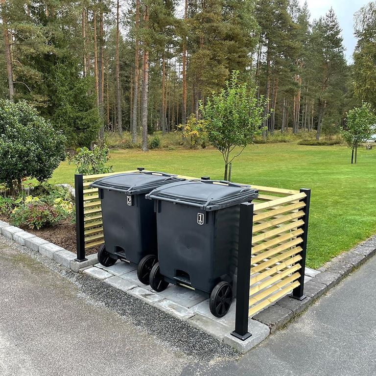 This is a simple and minimal solution to make your trash can less unsighty: slats attached to metal poles.