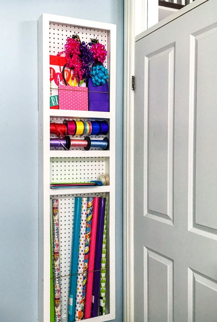 This sleek narrow shelf is done with pegboard and it's a whole gift wrapping station in a tiny corner.
