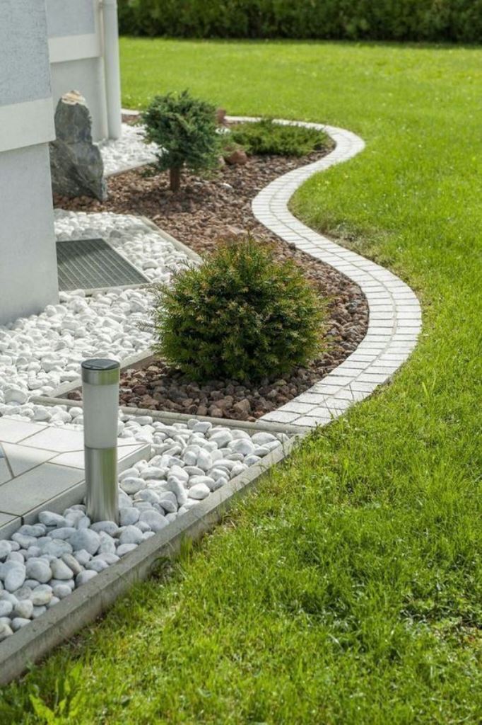 This curved small garden bed styles the corner of the house adding curb appeal to it.