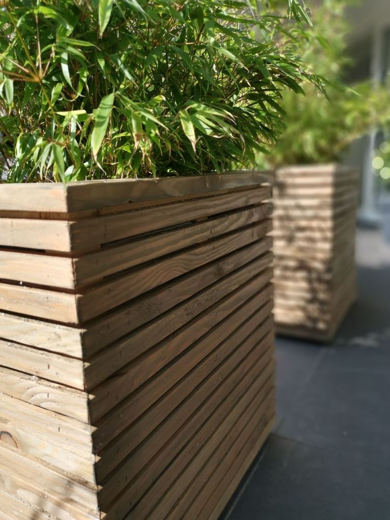 These stained containers with greenery will elevate the look of your outdoor space and make it contemporary.