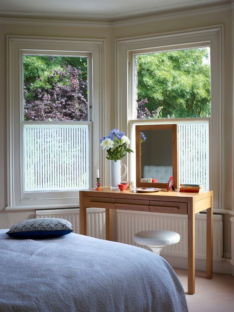 The bay window is done with striped film to keep privacy without any curtains and block anything unwanted.