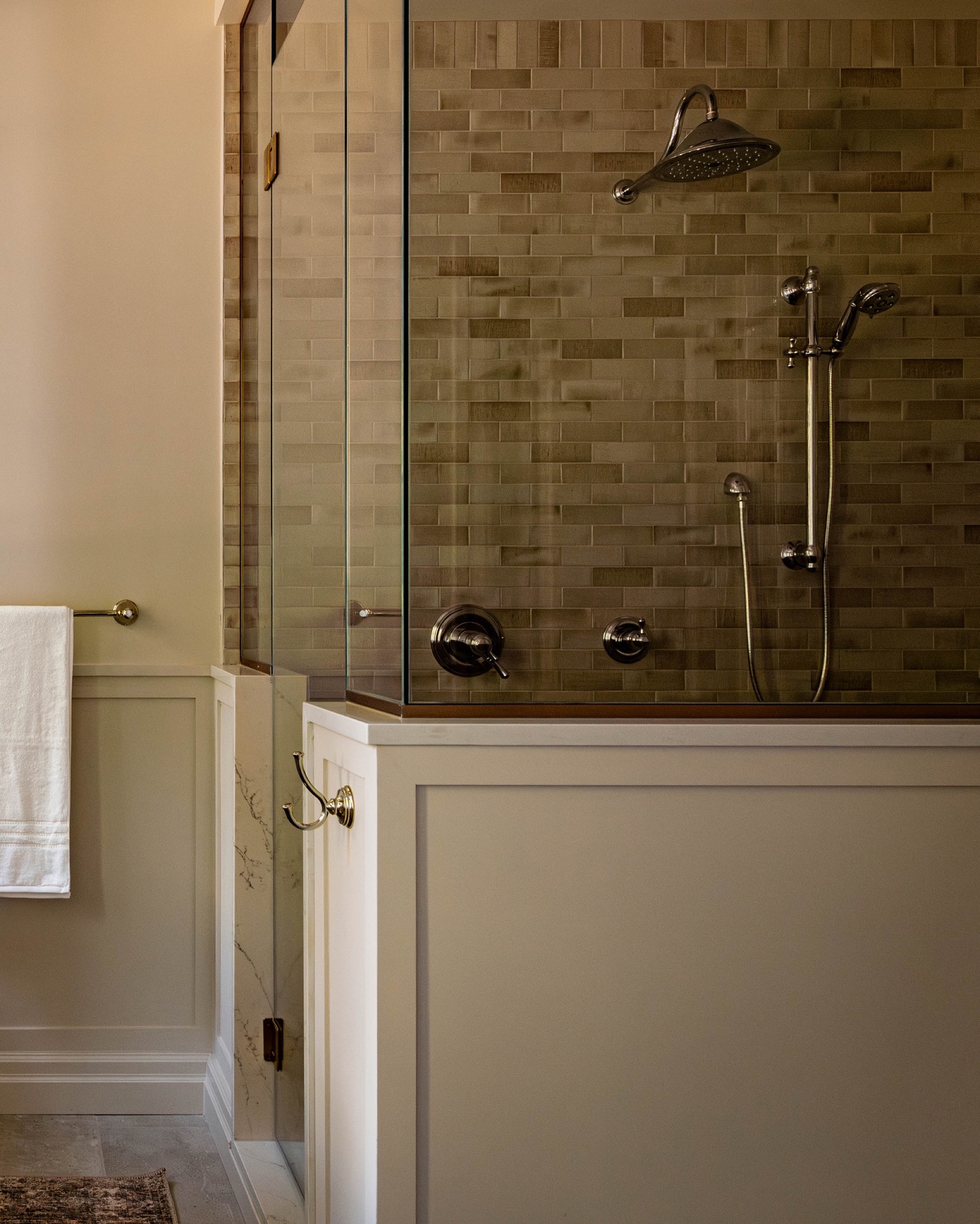 This design blends classic and contemporary elements, using a half wall to give the shower a timeless appeal.  (@westofmain).