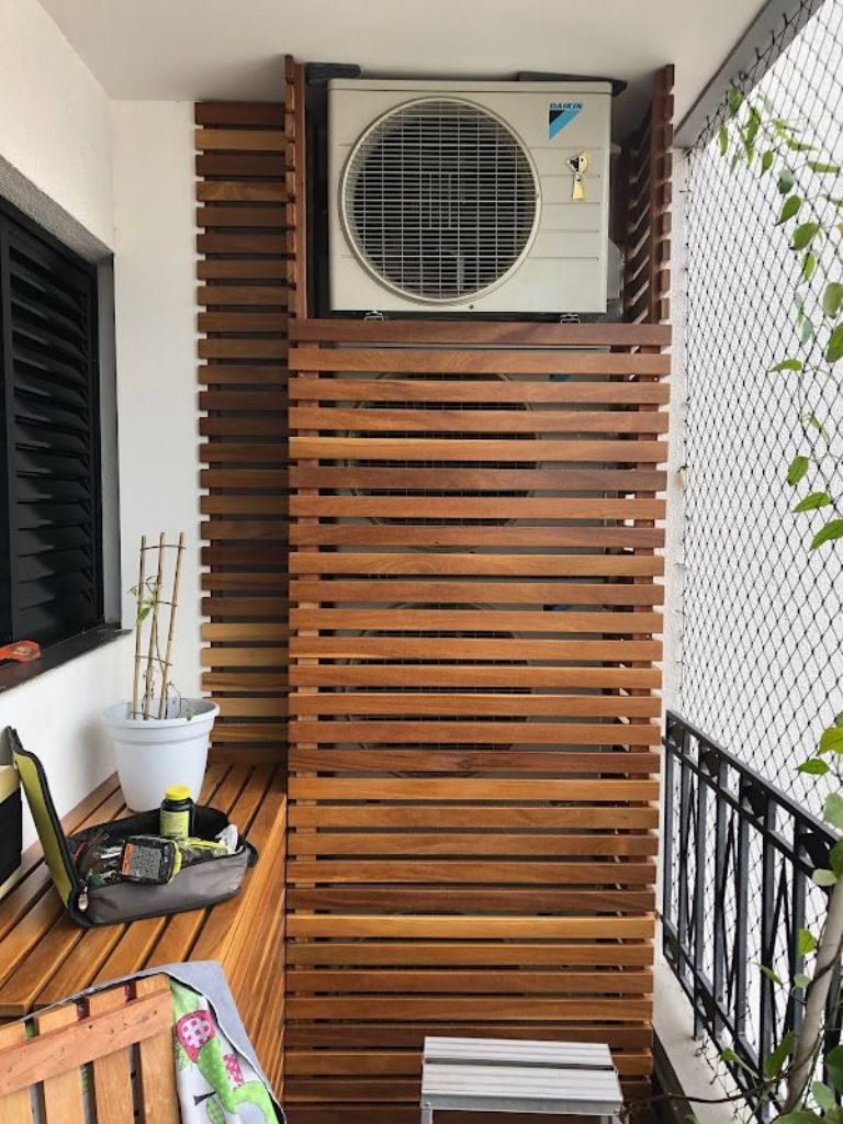 The small balcony features a whole stack of AC units that are covered with slatted screens.

(via atelierdozero).