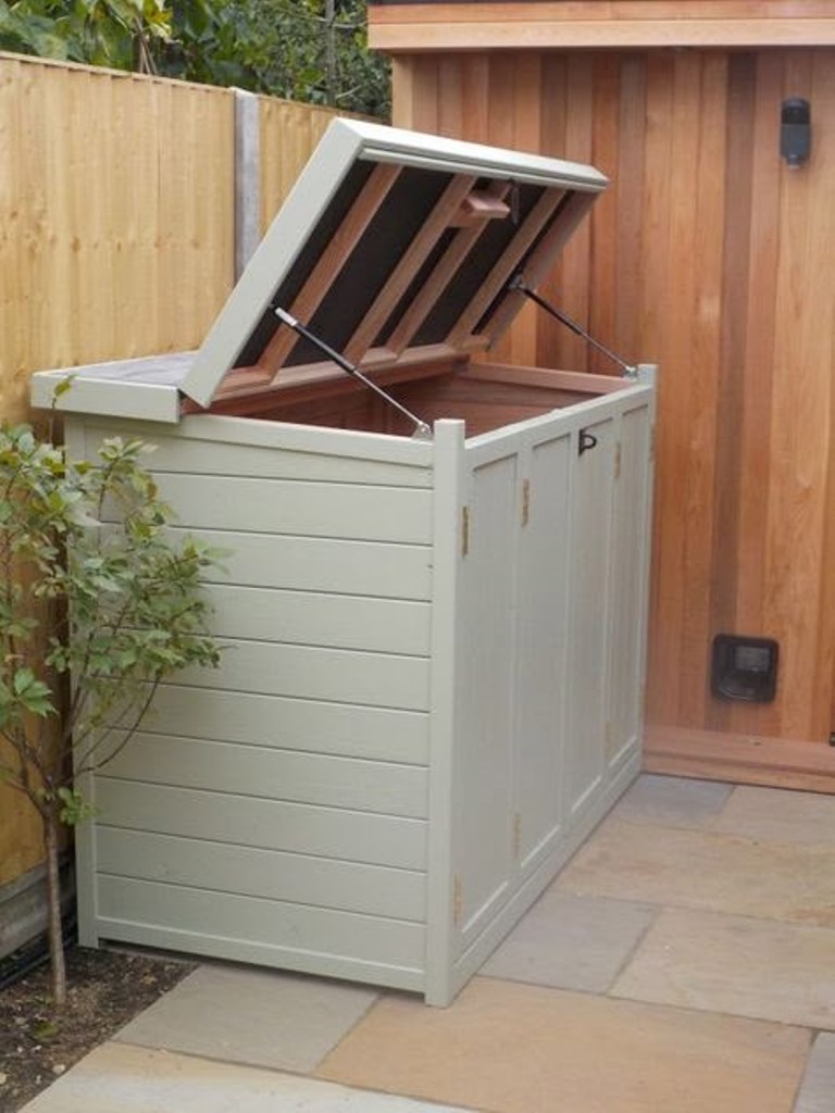 This white box with a lid is a nice solution for delicately hiding the trash cans and matching the outdoor space.